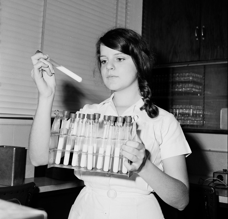 Cover image portrays a lady holding test tubes filled with milk.